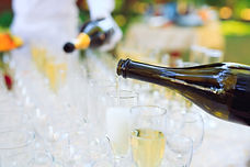 bartender-pouring-champagne-into-glasses