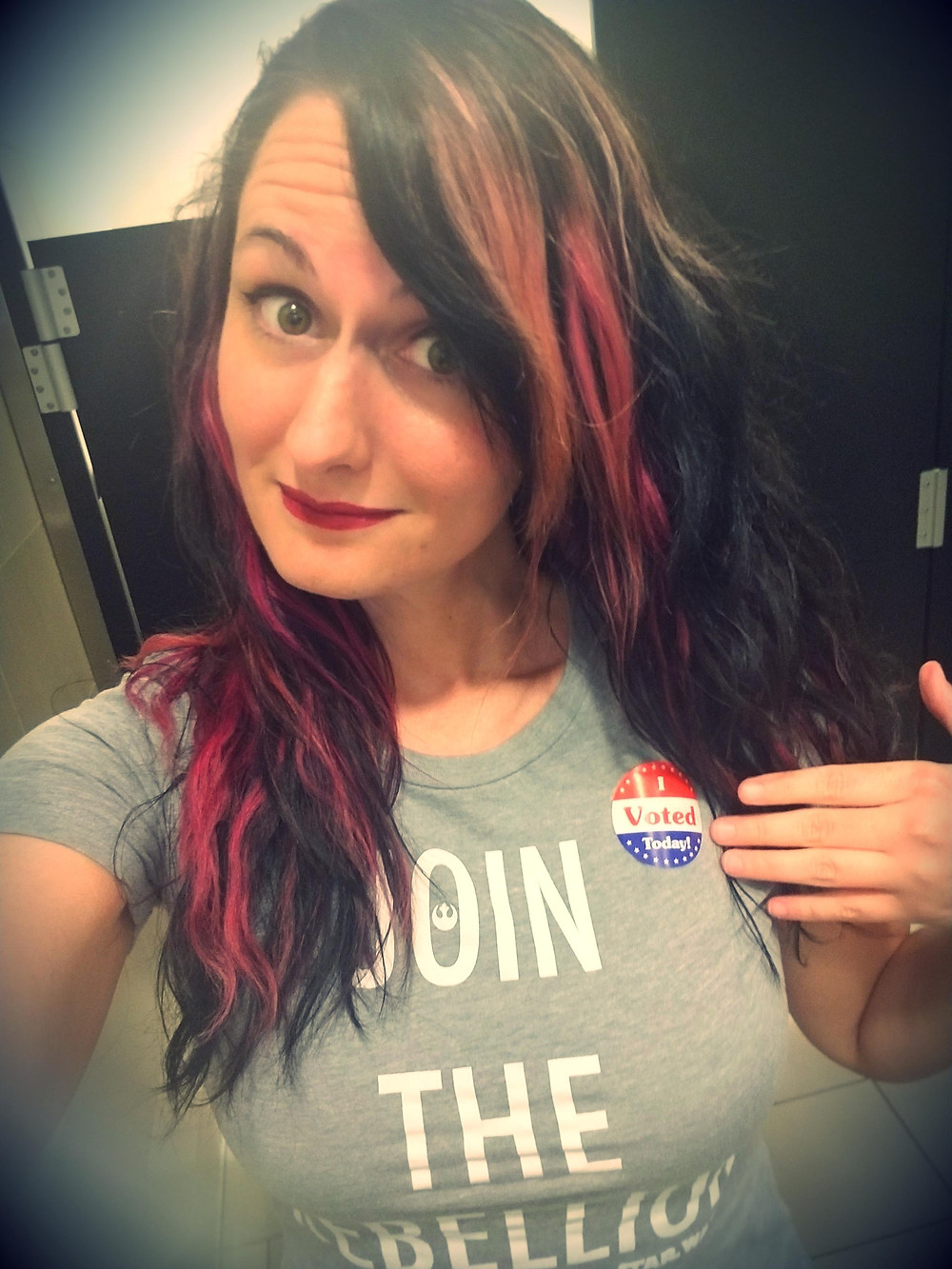 Writer Allison Babka wears a shirt that says "Join the rebellion" and an "I voted" sticker
