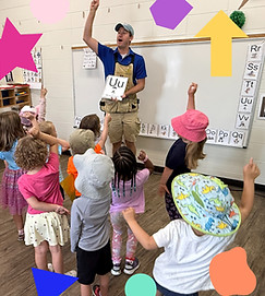 Children and male preschool teacher in a classroom moving together to Active Alphabet