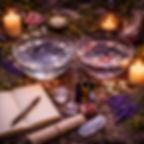 Moon ritual tools flat lay with water, essential oils, pen, and Book of Shadows