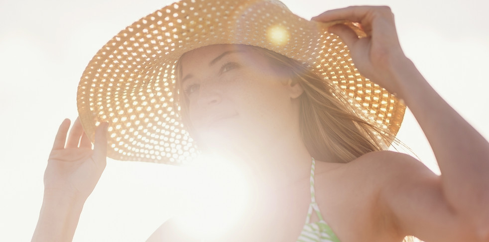 Young Woman in Sun Hat on Beach