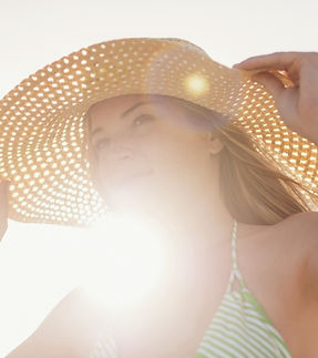 Young Woman in Sun Hat on Beach