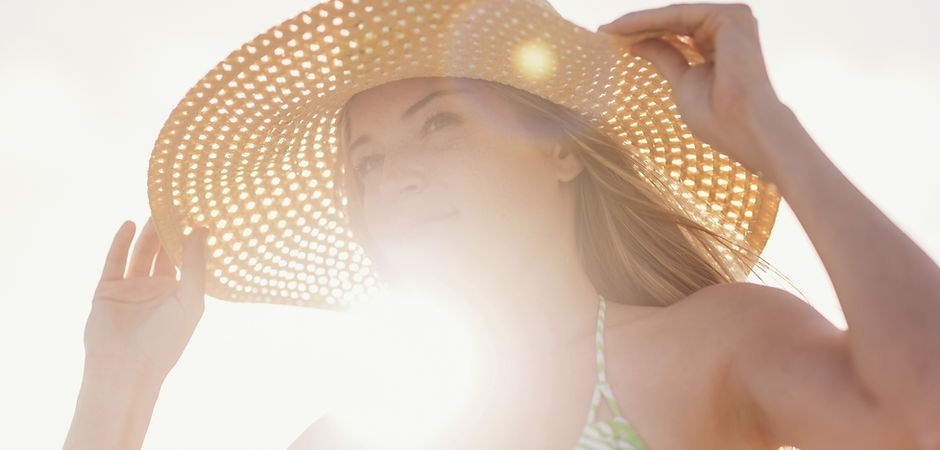 Young Woman in Sun Hat on Beach