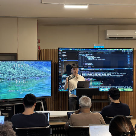Collaborative learning environment at the 'Building Your AI Assistant' event, fostering AI development skills.