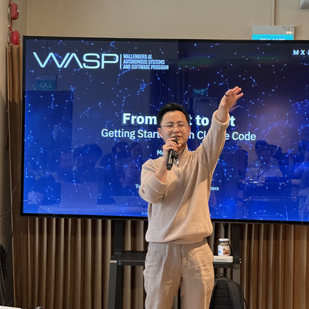 Speaker presenting on physical AI concepts at The Stage during a Co-work Fridays session for builders.