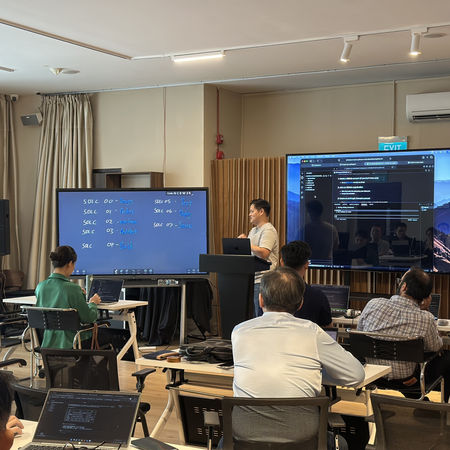 Attendees engaged in a practical technical workshop during John Ang's Masterclass, featuring live presentations and hands-on learning.