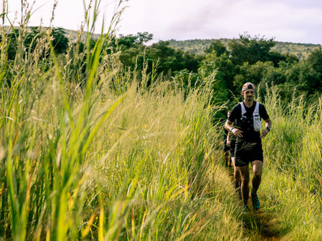 A trail runner navigating the scenic riverine section of the Harties River Trail in Hartbeespoort.