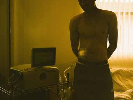 Justin Pham connecting his peritoneal dialysis cycler at home during his nightly setup routine