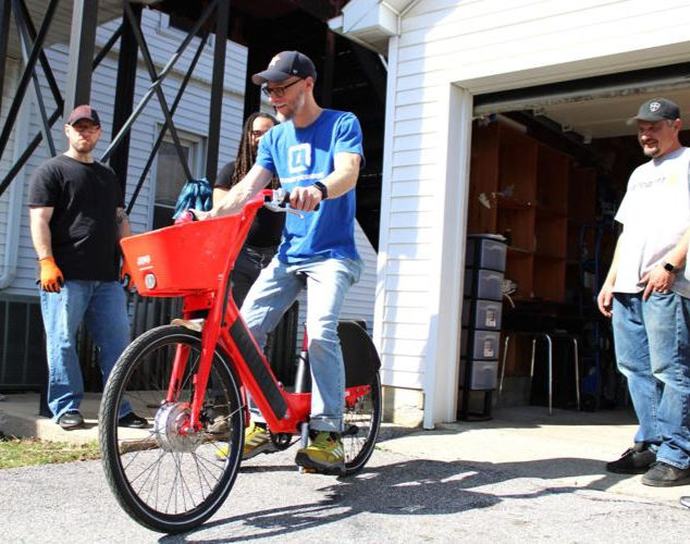 Tomorrow's Neighbors Director Kurt Kanysh riding an e-bike