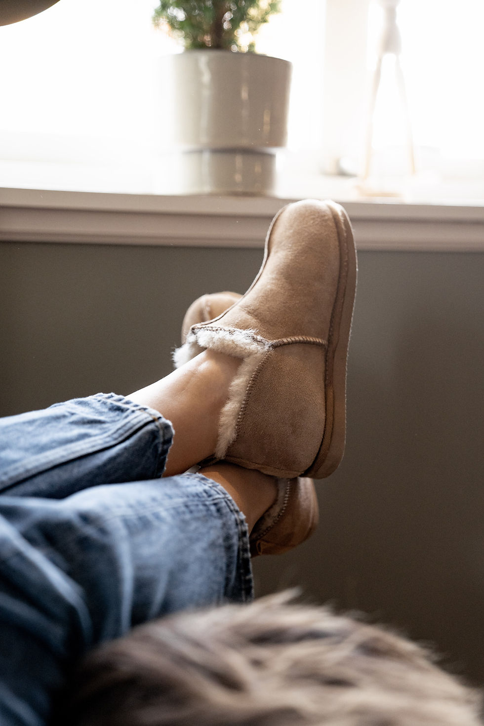 a person relaxing in a pair of Shepherd of Sweden Annie Slippers Stone