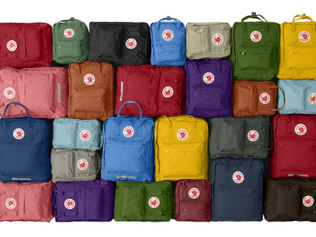 a wall of brightly coloured kanken packs