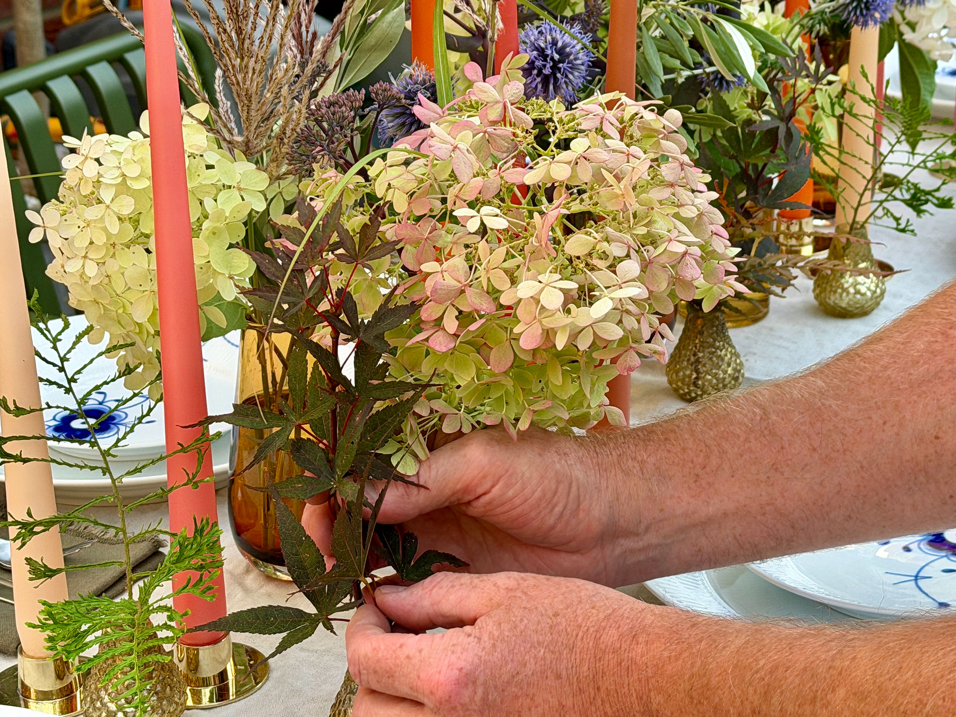 placing foliages on the dinner table - blomster designs