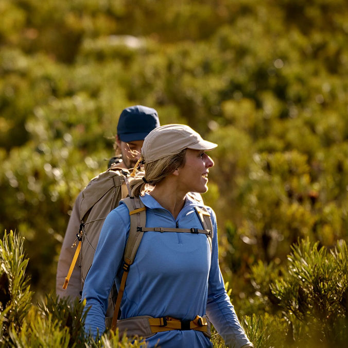 a man and a lady hiking in nature
