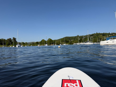 a red paddle board on a lake