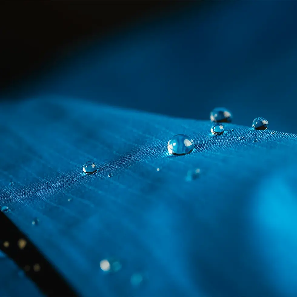 water beading on a blue coat