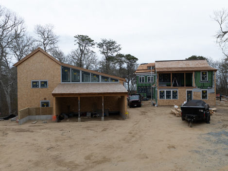 Construction site with multiple buildings and vehicles.