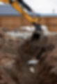digger filling drainage trenches