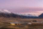 View of the Lindis Lodge with snow-capped mountains