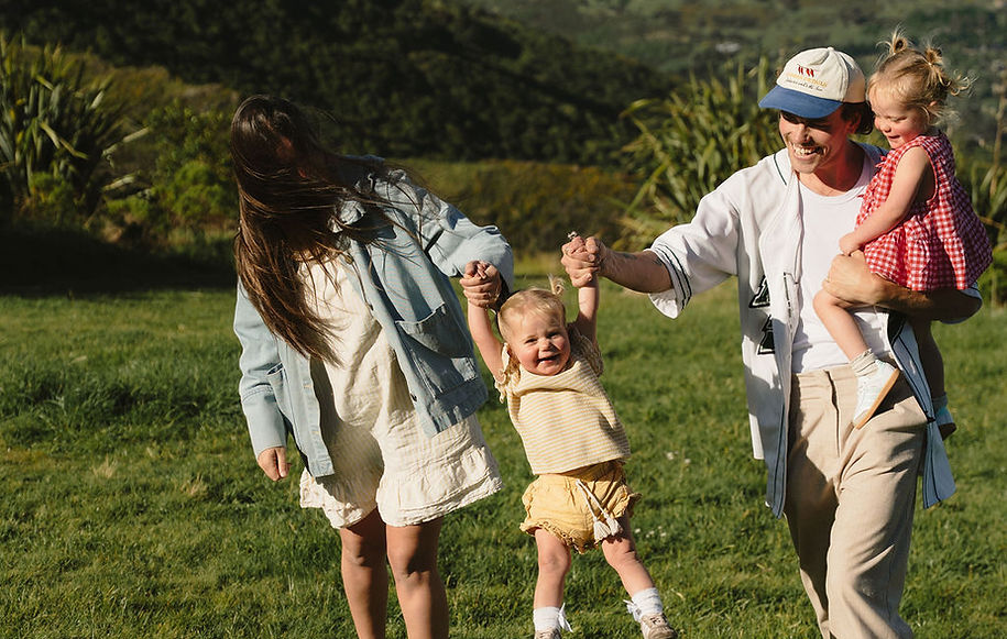 Happy, carefree family holding hands in New Zealand
