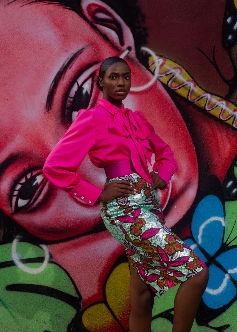 a silk pink blouse with a big bow and with a mint african printed pencil skirt.