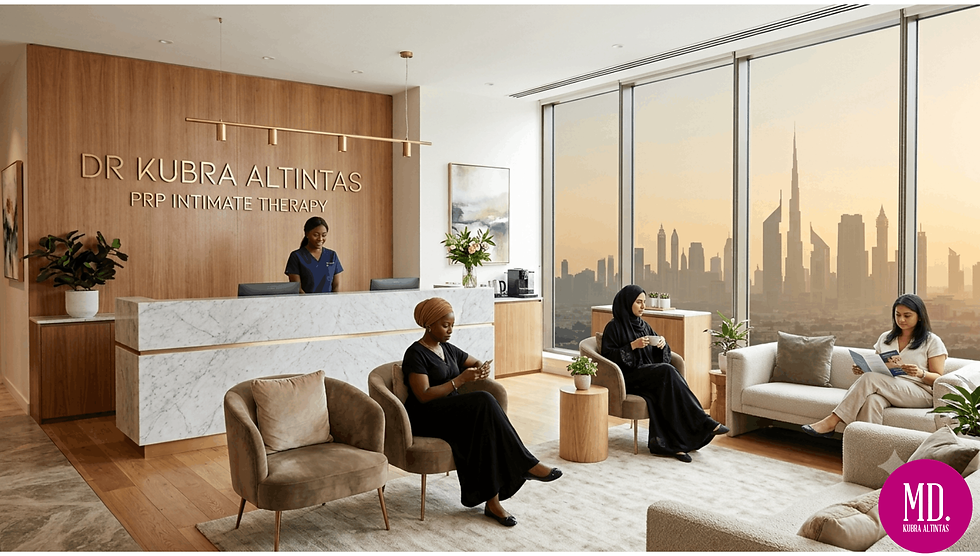 A luxurious, spacious, and modern medical clinic interior in Dubai, illuminated by bright natural light from floor-to-ceiling windows showing a city skyline view. The room features a polished white marble floor, a grey central treatment bed, and a specialized medical laser device on wheels in the foreground. The right side features a smooth, light-wood paneled wall with the text "Dr Kubra Altintas" in elegant bold lettering, followed by "Laser Vaginal Tightening - Dubai" underneath. The background includes minimalist clinic furniture, a digital monitor display, and a clean, premium aesthetic.