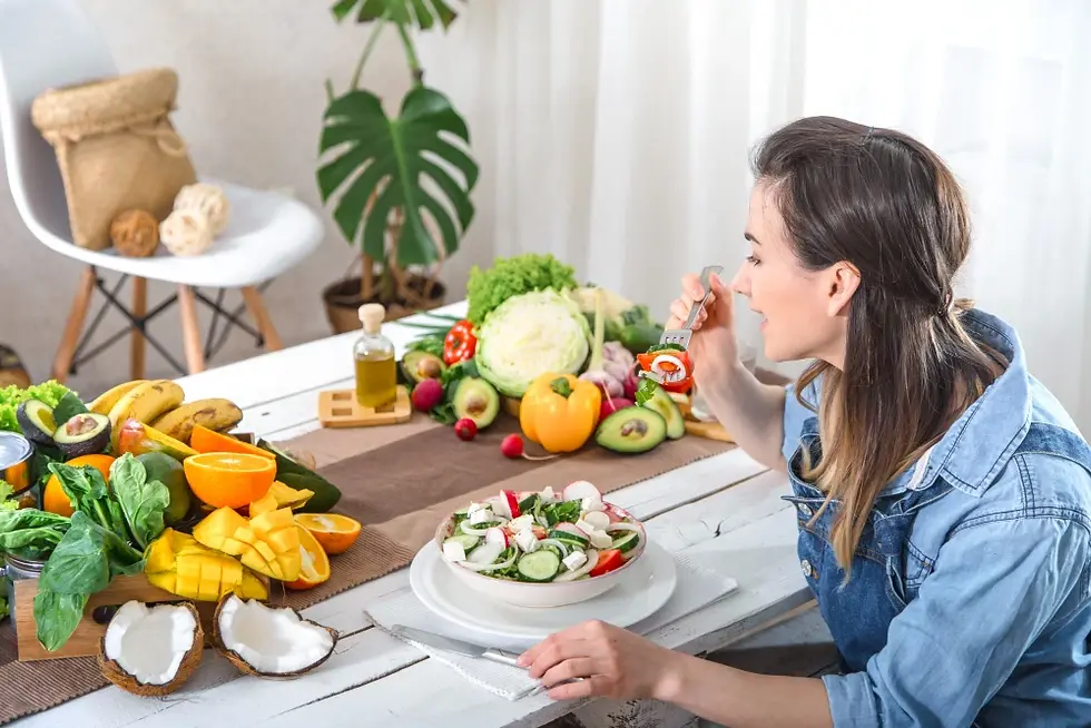 Fresh, colorful foods on wooden table: broccoli, oranges, spinach, oats, chicken, salmon, avocado, berries, nuts. Healthy eating theme.