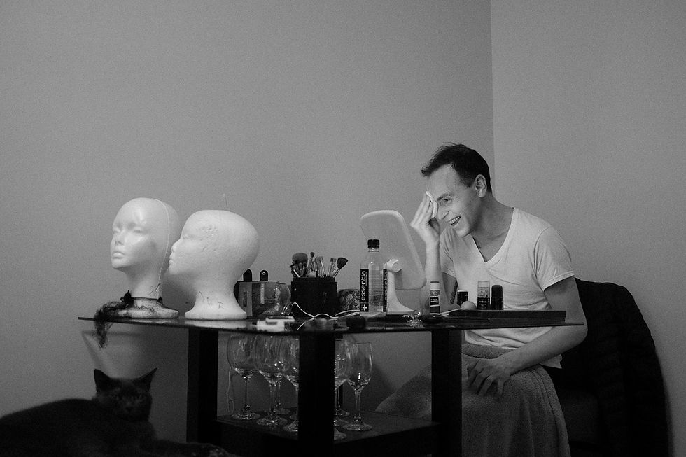 drag queen getting makeup ready and cat sitting