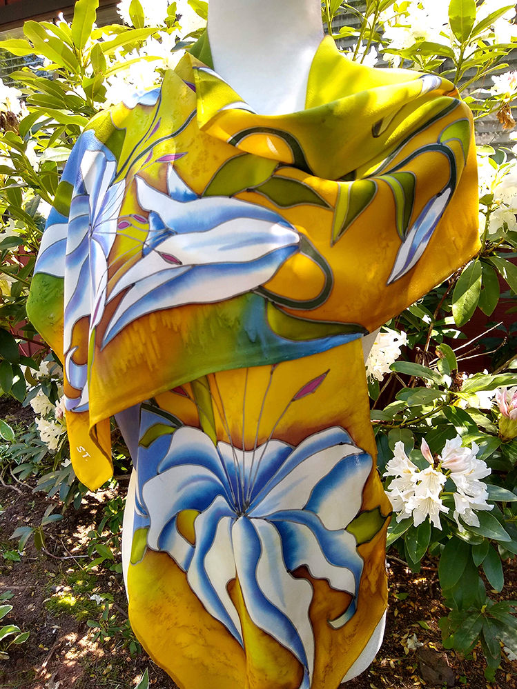 Thumbnail: Floral silk scarf with large white lilies and golden-yellow background, folded in layers.