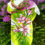 Thumbnail: Front view of Green and Pink Floral Silk Scarf styled around neck with lily flower pattern visible
