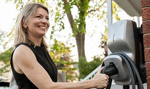 woman holding an EV charger