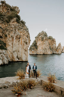 Flower decorations of a late summer marriage at Tonnara di Scopello, luxury wedding venue in Sicily, Italy.
Orange and warm tones, sicilian vibes for a late sumemr wedding of bride and groom.
Symbolic ceremony held at the terrace of Tonnara di Scopello with an enchating view of the Faraglioni di Scoplelo as backdropp. Wedding and entire wedding weekend planned and designed by Amuri Events & Wedding planner, sicily luxury wedding planner and designer, Italy. shot by Martina Botti, vogue photographer