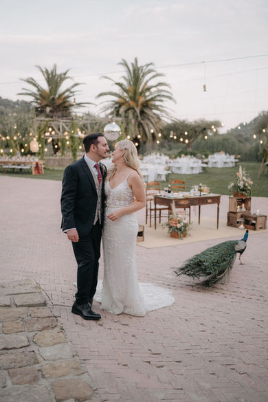 Bride and Groom in companion of Tenuta Savoca's peacock. 