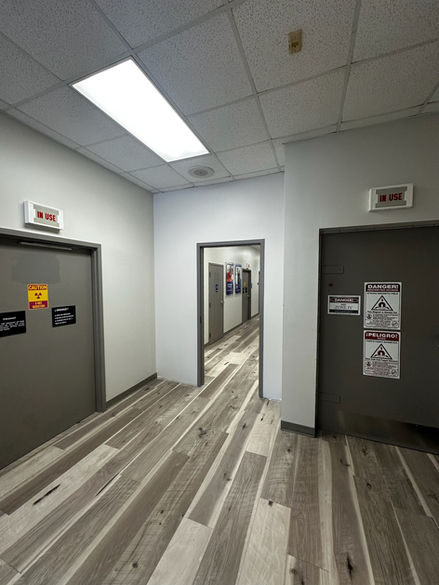 Office hallway with doors and wood-look flooring