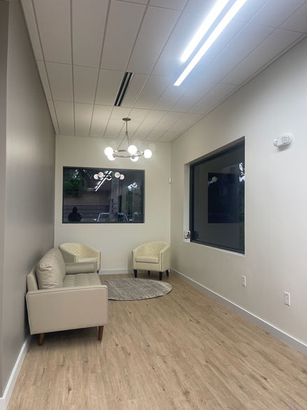 Waiting area with beige chairs and large window