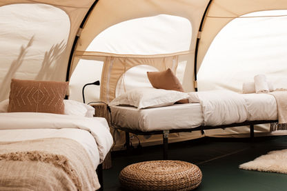 Inside of a lotus tent with two single beds and beautiful decorations