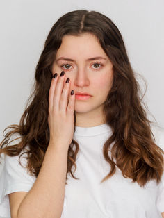 Polas comédienne cadrage serré visage, fond blanc studio. Expression neutre, lumière douce et naturelle pour directeurs de casting et agences artistiques.