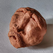 Clay ocarina shaped as a face of an old man.