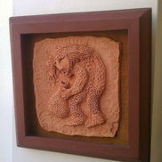 Man with a beard and long hair holding a clay vessel.