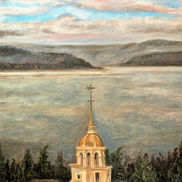 An old church bell tower against a background of calm water and distant islands.