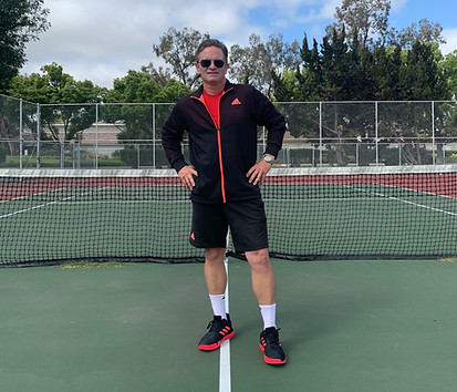 Coach Jimmy Gleason on an outdoor tennis court in Irvine, California.