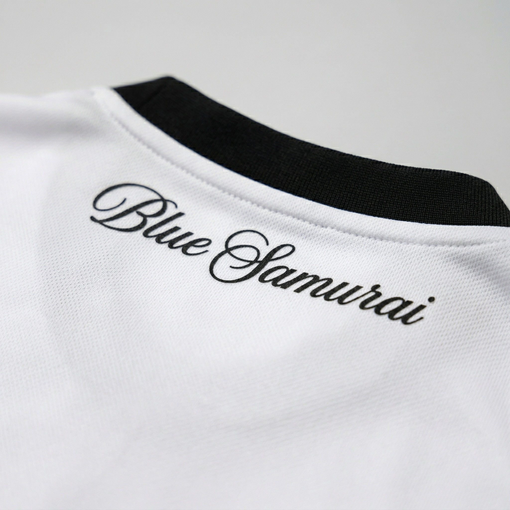 Close-up of “Blue Samurai” text on collar of Japan custom soccer jersey with detailed finish