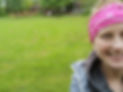 Shani - Owner of Strong Mama Fitness, standing in a field with class setup behind her