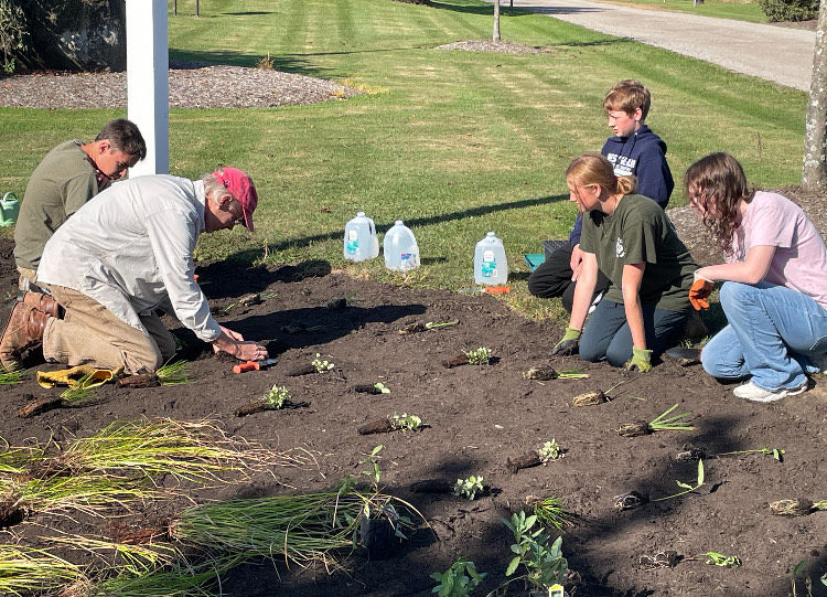 Caroline Yeager and volunteers installing the rain garden.