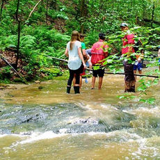 campers in a stream