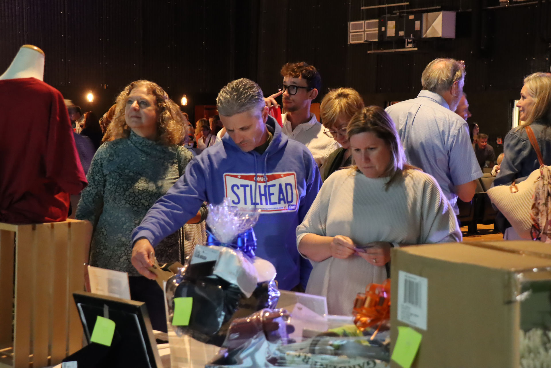 People viewing silent auction items