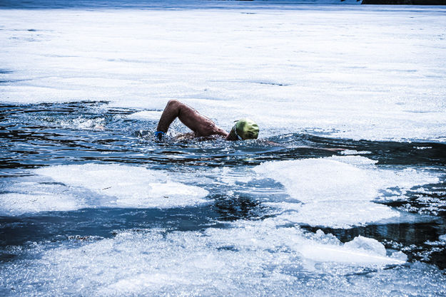 Ice swimmer Josef Köberl swimming in frozen lake Austria