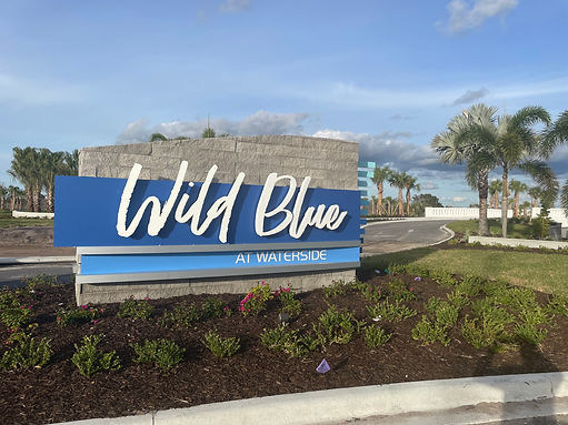 A welcome sign that says Wild Blue at Waterside