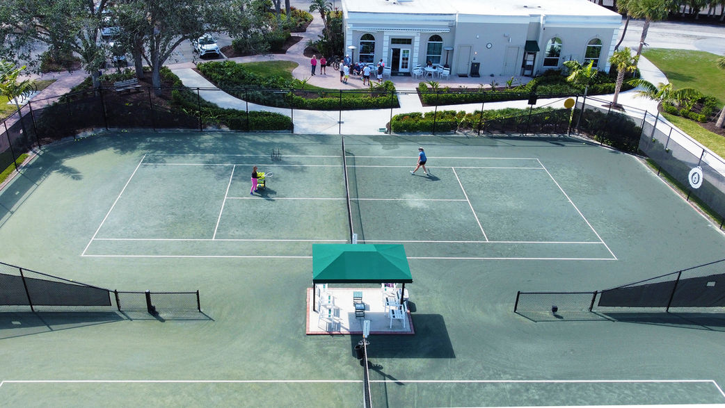 People playing on a tennis court in Boca Royale