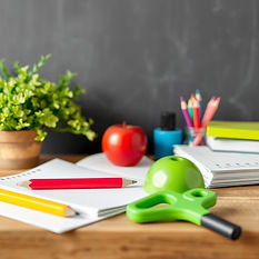 Desk with papers, writing utensils and a plant