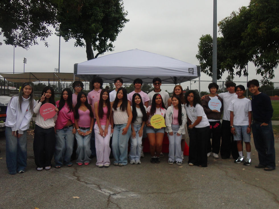 A lively group from m4m assembles in Pasadena, coming together in advocacy and smiles beneath a canopy, holding colorful signs to promote their cause.